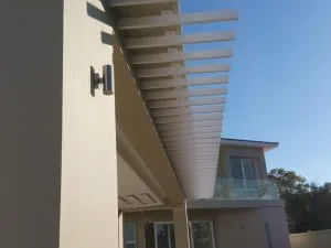 Sun louvre awning over an enclosed outdoor living space